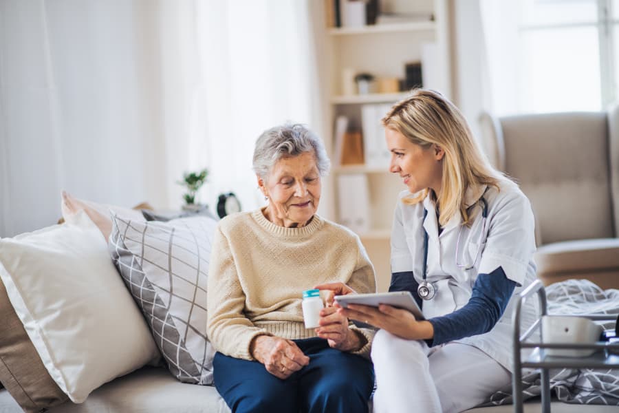 Caregiver Assisting Senior With Medication